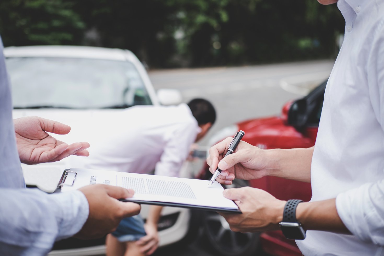 Insurance Agent Examine Damaged Car and Customer Filing Signature